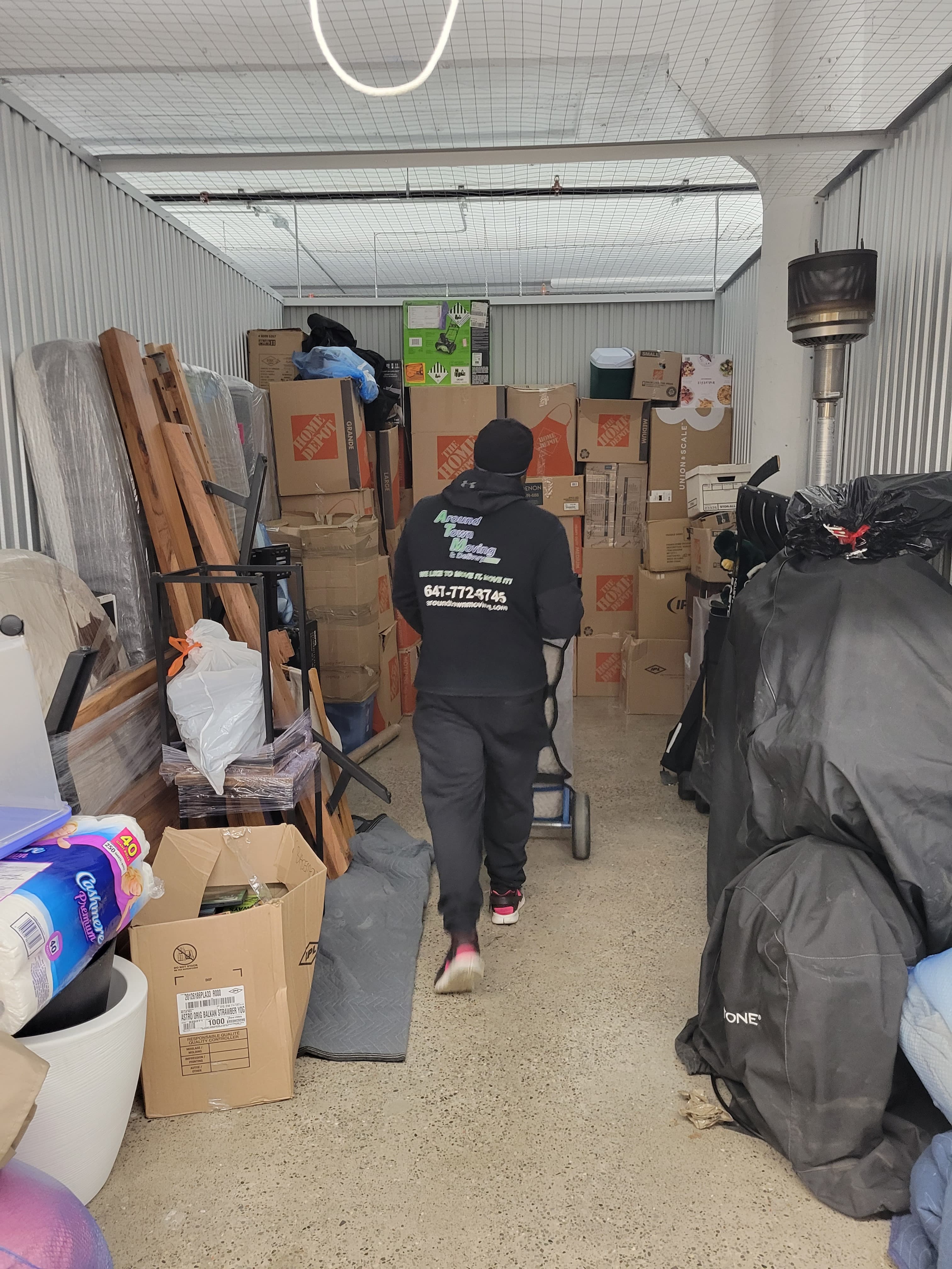 Full garage junk removal cleanout service in Toronto with piled cardboard and household items